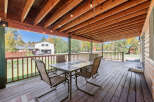 Enjoy outdoor living on this spacious covered deck, perfect for entertaining or relaxing.