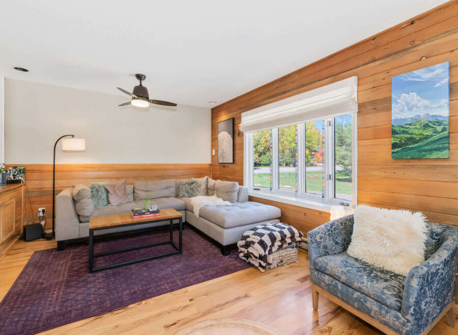 Experience cozy living in this inviting living room, featuring a plush sectional sofa and a stylish armchair perfect for relaxation.
