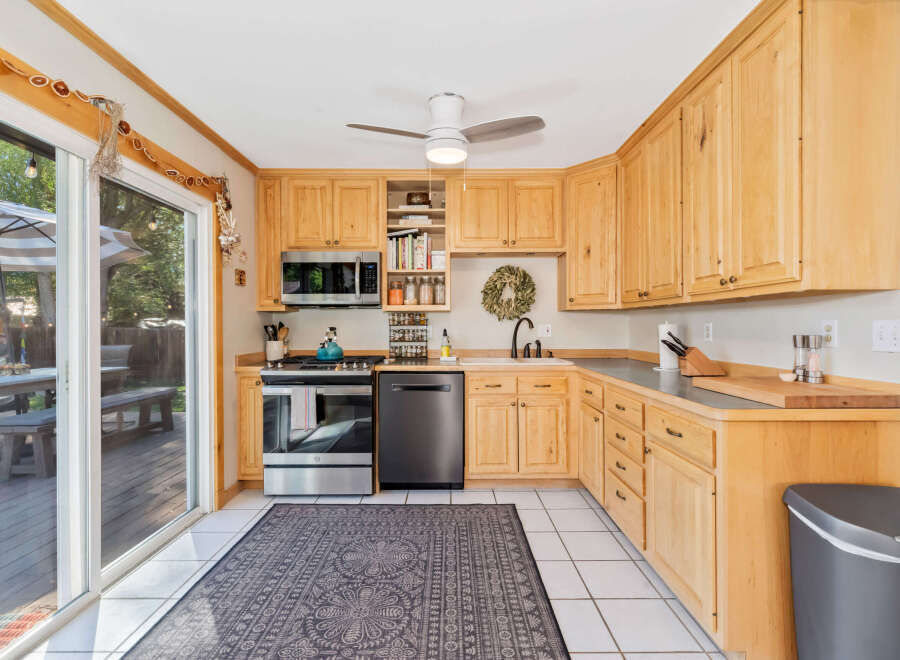 This charming kitchen boasts natural light and ample storage with its beautiful light wood cabinetry.