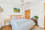 Discover this charming bedroom featuring a comfortable bed adorned with decorative pillows and a light blue throw.