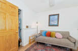 This cozy living space features a comfortable grey sofa adorned with colorful round pillows, perfect for relaxation.