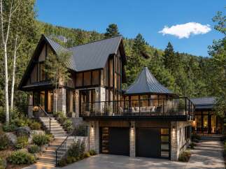 Experience luxury mountain living in this stunning modern home, nestled amidst lush greenery and rolling hills.