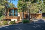 Nestled among tall pine trees, this unique A-frame home offers stunning natural light through its expansive floor-to-ceiling windows.