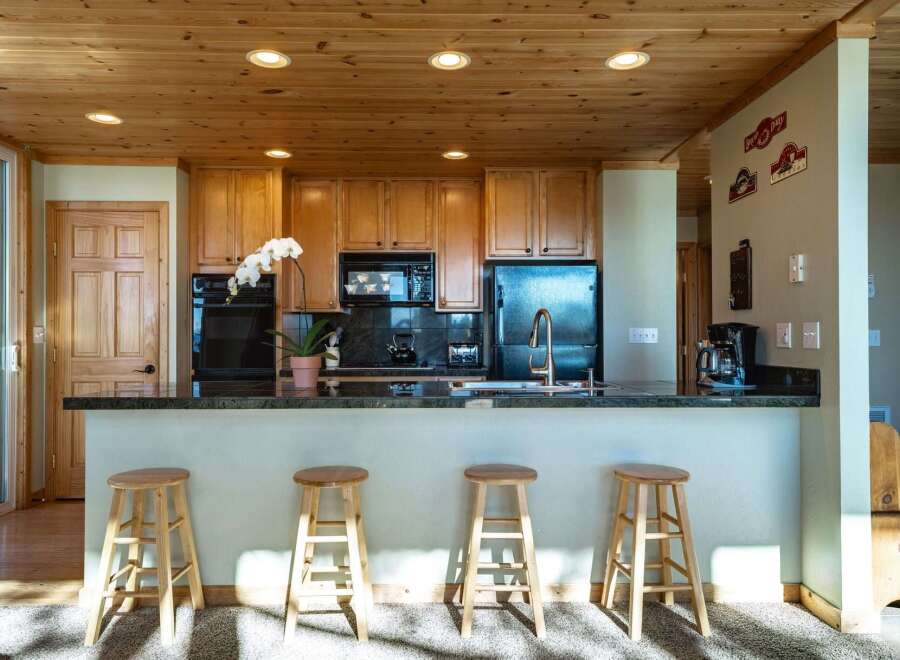 Step into this inviting kitchen featuring warm wood cabinetry and a sleek granite countertop.