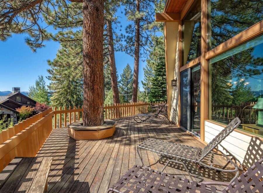 Enjoy the stunning natural beauty from this expansive wooden deck, perfect for outdoor living and entertaining.