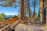 Enjoy breathtaking lake and mountain views from this expansive wooden deck, perfect for entertaining or relaxing.