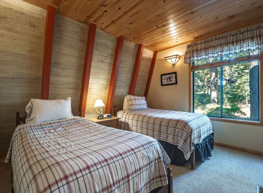 Discover cozy comfort in this charming bedroom featuring two twin beds, perfect for guests or family.
