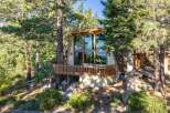 Nestled amidst towering pine trees, this A-frame home offers a unique architectural design with expansive windows that flood the interior with natural light.