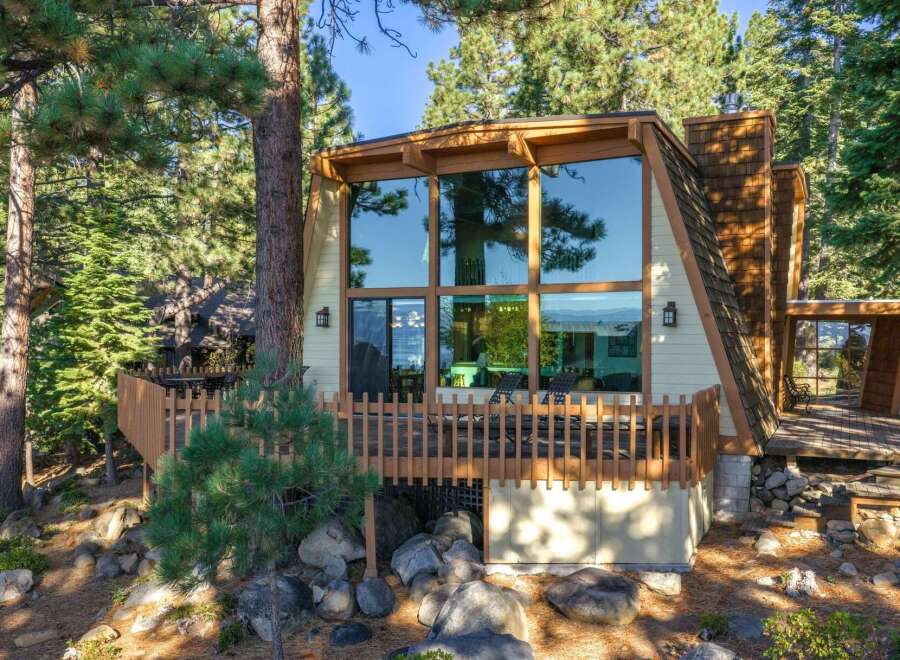 Experience breathtaking lake and mountain views from this stunning A-frame home, featuring a wall of windows that flood the interior with natural light.