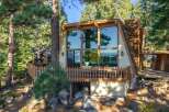 Experience breathtaking lake and mountain views from this stunning A-frame home, featuring a wall of windows that flood the interior with natural light.