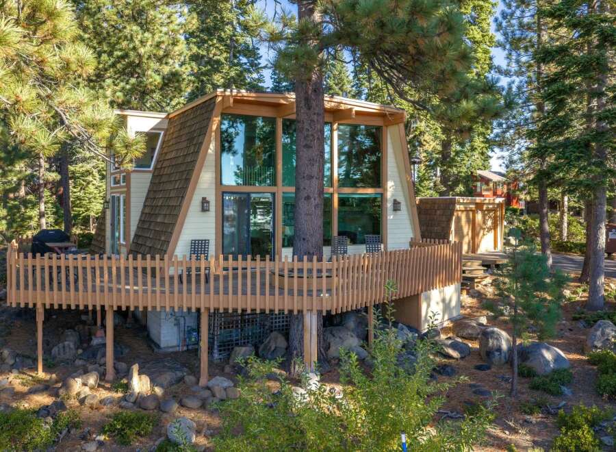 Experience the charm of this A-frame cabin nestled amongst tall pine trees.