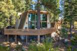 Experience the charm of this A-frame cabin nestled amongst tall pine trees.
