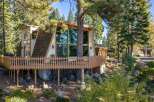 Nestled amidst towering pine trees, this unique A-frame home offers a captivating blend of rustic charm and modern living.