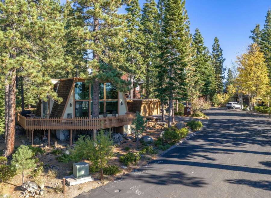 Nestled among tall pine trees, this unique A-frame home offers stunning natural beauty and modern comfort.