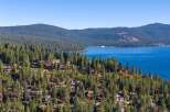 Discover luxury living nestled amidst the towering pines with breathtaking views of a pristine blue lake.