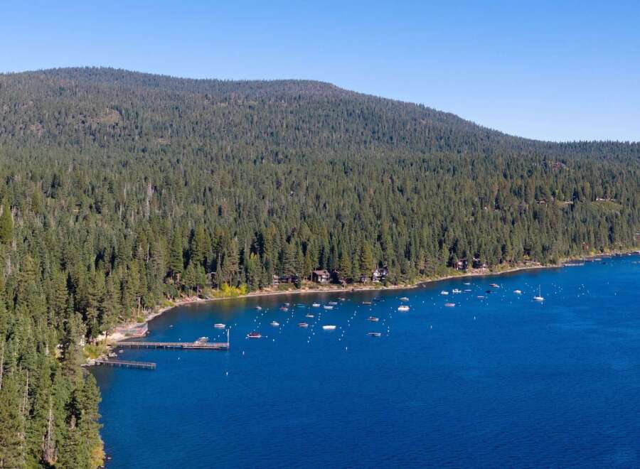 Experience the ultimate lakeside living with this stunning aerial view of a serene bay.