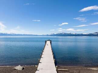 Experience the ultimate lakeside lifestyle with this stunning property featuring a private pier extending into crystal-clear waters.