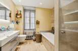 This charming bathroom features a spacious bathtub and a separate shower enclosure, perfect for relaxation and rejuvenation.