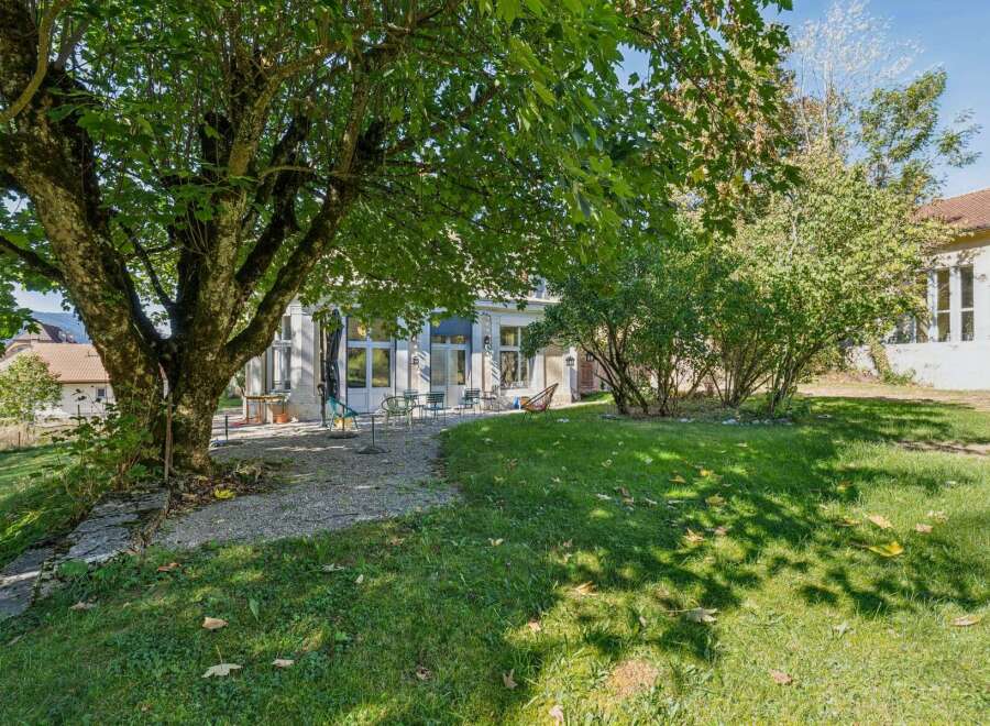 Enjoy the outdoors in this charming property featuring a spacious backyard with a large, mature tree providing ample shade.
