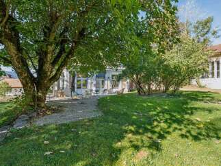 Enjoy the outdoors in this charming property featuring a spacious backyard with a large, mature tree providing ample shade.