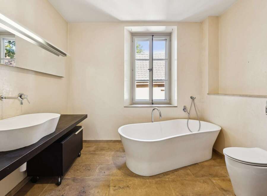 Experience luxury in this stunning bathroom featuring a freestanding soaking tub, perfect for unwinding after a long day.
