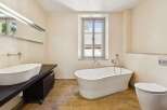 Experience luxury in this stunning bathroom featuring a freestanding soaking tub, perfect for unwinding after a long day.