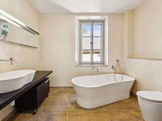 Experience luxury in this stunning bathroom featuring a freestanding soaking tub, perfect for unwinding after a long day.