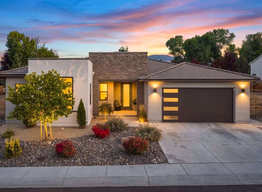Experience modern luxury in this stunning single-story home, featuring a striking stone-accented facade and a sleek, contemporary design.