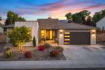 Experience modern luxury in this stunning single-story home, featuring a striking stone-accented facade and a sleek, contemporary design.