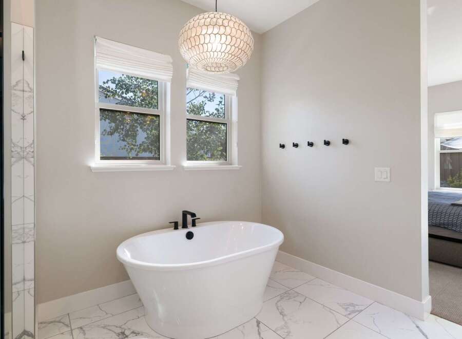 Indulge in relaxation in this luxurious bathroom, featuring a freestanding soaking tub perfect for unwinding.
