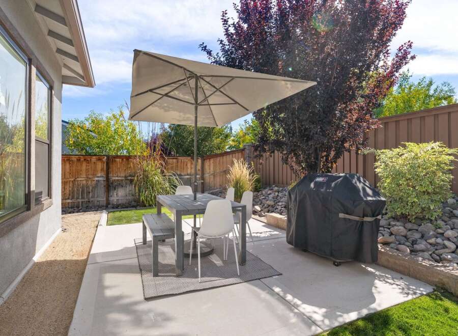 Enjoy outdoor living in this charming backyard featuring a spacious patio perfect for al fresco dining.
