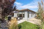 Enjoy outdoor living with this charming backyard featuring a covered patio, perfect for al fresco dining.