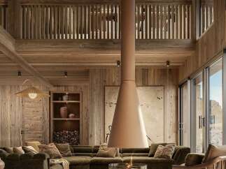 Experience luxury mountain living in this stunning chalet, featuring a soaring wood-paneled ceiling and a modern suspended fireplace.