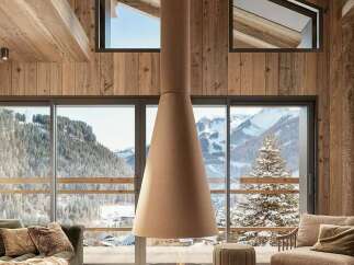 Experience the ultimate mountain retreat in this stunning chalet, featuring a modern suspended fireplace as the centerpiece of the living area.