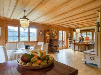 Experience rustic charm in this beautifully appointed dining room, featuring warm wooden paneling and a beamed ceiling.