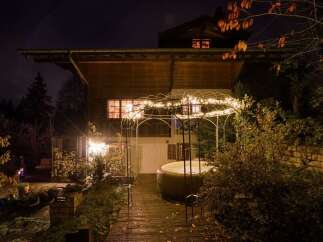 Experience ultimate relaxation in this charming property featuring a luxurious outdoor hot tub, perfect for unwinding under the night sky.