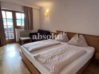 Experience comfort and style in this beautifully appointed bedroom, featuring a spacious bed with plush linens and two inviting pillows.