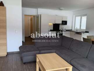Discover modern living in this open-concept apartment featuring a sleek, integrated kitchen with ample cabinet space and a spacious living area perfect for relaxation and entertaining.