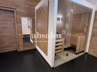Experience ultimate relaxation in this modern sauna, featuring a glass-enclosed design and warm wooden interiors.