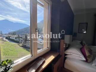 Wake up to breathtaking mountain views from this charming bedroom.