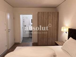Discover comfort and style in this well-appointed bedroom, featuring a spacious wardrobe and an en-suite bathroom.