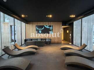 Relax and unwind in this modern spa area, featuring comfortable lounge chairs and a serene ambiance.