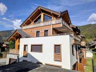 Experience modern alpine living in this stunning wooden chalet-style property, featuring expansive balconies with breathtaking mountain views.