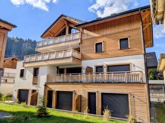 Experience modern alpine living in this stunning multi-story residence featuring a harmonious blend of natural wood and white stucco exteriors.