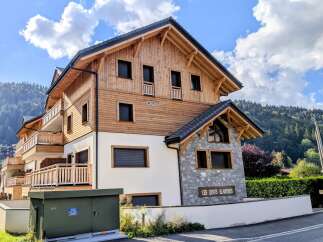 Discover this stunning modern chalet-style property, featuring a beautiful blend of natural wood and stone accents.