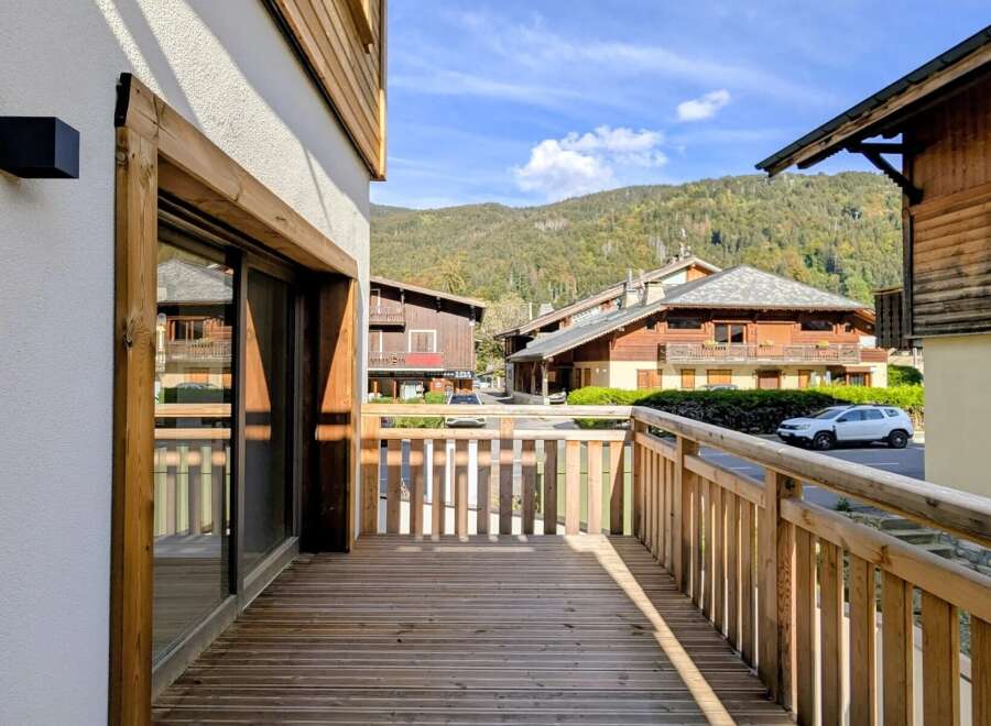 Enjoy the stunning mountain views from this charming wooden balcony, perfect for your morning coffee or evening relaxation.
