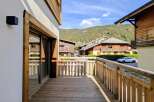 Enjoy the stunning mountain views from this charming wooden balcony, perfect for your morning coffee or evening relaxation.