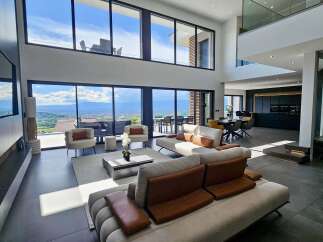 Experience luxurious modern living in this spacious open-plan home, featuring floor-to-ceiling windows that offer breathtaking panoramic views of the surrounding landscape.