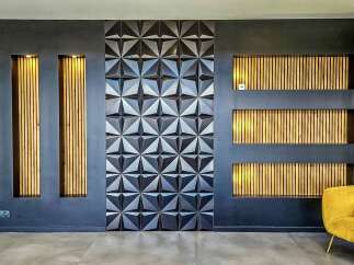 Experience modern luxury with this stunning feature wall, showcasing a captivating geometric tile design and integrated wooden slat panels with warm accent lighting.