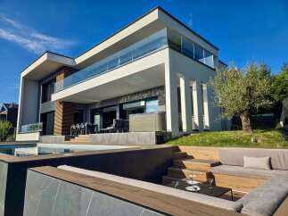 Experience luxury living in this modern architectural masterpiece featuring a stunning infinity pool and a spacious outdoor entertaining area.